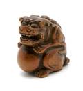 A Carved Wood Netsuke of a Buddhistic Lion
