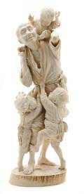 A Figural Ivory Model of a Man with Three Boys