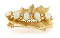 An 18 Karat Yellow Gold Opal and Diamond Pin