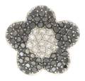 An 18 Karat White Gold White Diamond and Black Diamond Flower Ring