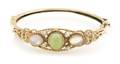 A 14 Karat Yellow Gold Light Green Jade Moonstone and Seed Pearl Hinged Bangle Bracelet