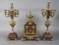 A French Gilt Metal and Rouge Marble Clock Garniture