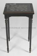 An Ebonized and Glass Inset Games Table