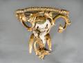 CARVED PAINTED AND GILTWOOD WALL BRACKET