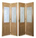 A Set of Four French Pine and Etched Glass BiFold Doors