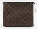 A Louis Vuitton Monogram Canvas Zippered MakeUp Case