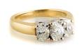 A 14 Karat Two Tone Gold and Diamond Three Stone Ring
