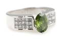 An 18 Karat White Gold Irradiated Green Diamond and White Diamond Ring