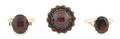 A Group of Three Yellow Gold and Garnet Rings