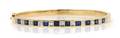 A 14 Karat Yellow Gold Sapphire and Diamond Bangle Bracelet