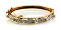 A 14 Karat Two Tone Gold and Diamond Bangle Bracelet