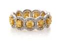 An 18 Karat White Gold Fancy Yellow and White Diamond Eternity Band