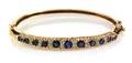 A 14 Karat Yellow Gold Sapphire and Diamond Bangle Bracelet