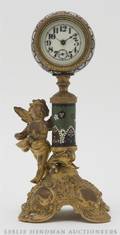 A French Gilt Metal and Champleve Figural Clock