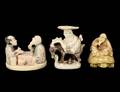 GROUP OF THREE CARVED AND POLYCHROMED IVORY NETSUKES