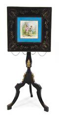 A Continental Ebonized and Sevres Style Porcelain Inset Gilt Metal Mounted Occasional Table