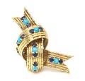 An 18 Karat Yellow Gold Turquoise and Sapphire Knot Brooch Tiffany  Co