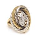 An 18 Karat Two Tone Gold and Diamond Oval Ring