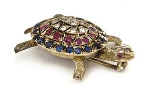 An 18 Karat White Gold Diamond Ruby and Sapphire Turtle Pin