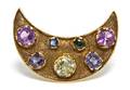 An 18 Karat Yellow Gold and Synthetic Sapphire Crescent Brooch
