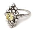 An 14 Karat White Gold and Fancy Yellow Diamond Cluster Ring
