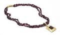 An 18 Karat Yellow Gold and Garnet Double Strand Necklace with Pendant