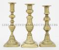A Group of Three Brass Candlesticks