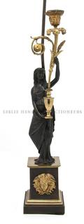 An Empire Patinated Gilt Bronze Figural Candlestick