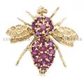 A 14 Karat Yellow Gold and Ruby Pin in an Insect Motif