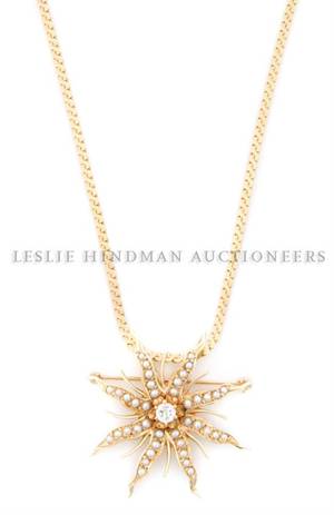 A 14 Karat Yellow Gold Seed Pearl and Diamond Flower Pendant