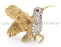 An 18 Karat Yellow Gold Diamond and Ruby Brooch in a Hummingbird Motif