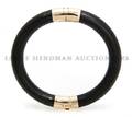 A 14 Karat Yellow Gold and Black Jadeite Bangle Bracelet
