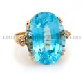 A 14 Karat Yellow Gold Blue Topaz and Diamond Ring