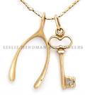 A 14 Karat Yellow Gold Necklace with Key and Wishbone Pendants