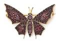A Gold Tone and Garnet Butterfly Brooch