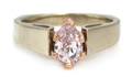 A Gold and Fancy Purplish Pink Diamond Solitaire Ring