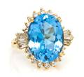 A 14 Karat Yellow Gold Blue Topaz and Diamond Ring
