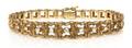 A 14 Karat Yellow Gold and Diamond Textured Bracelet
