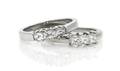 A Pair of Platinum and Diamond Three Stone Bands