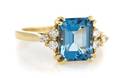A 14 Karat Yellow Gold Blue Topaz and Diamond Ring