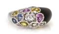 An 18 Karat White Gold Onyx and Multi Color Sapphire Bombe Ring