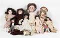 A Collection of Eight Porcelain Head Dolls