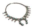 A Native American Silver and Turquoise Squash Blossom Necklace
