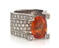 An 18 Karat White Gold Orange Sapphire and Diamond Ring