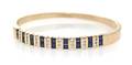 A 14 Karat Yellow Gold Sapphire and Diamond Bangle Bracelet