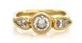 A 14 Karat Yellow Gold and Diamond Three Stone Ring