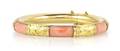 A 14 Karat Yellow Gold and Coral Bangle Bracelet