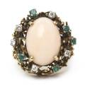 An 18 Karat Yellow Gold Coral Diamond and Emerald Ring