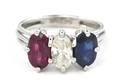 A Platinum Ruby Sapphire and Diamond Three Stone Ring