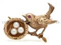 A 14 Karat Yellow Gold and Cultured Pearl Pin in a Bird and Nest Motif